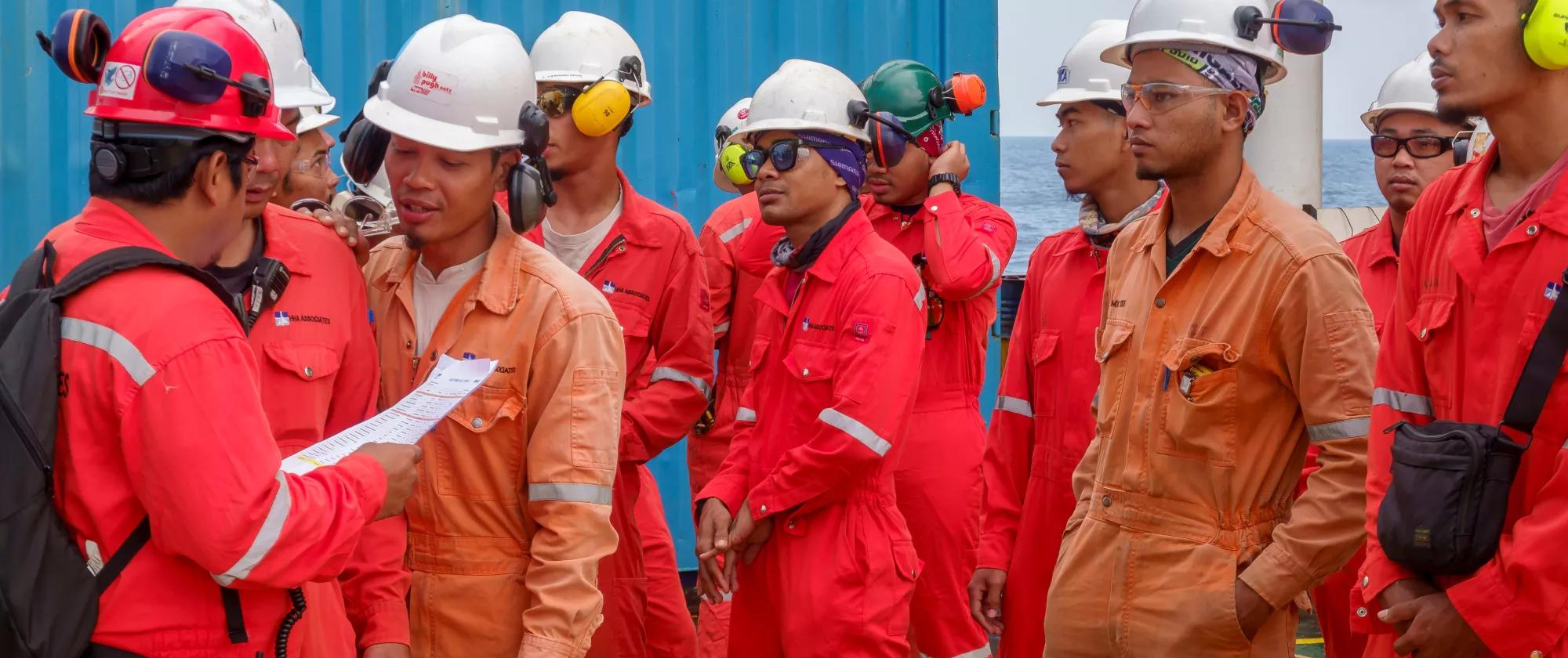 A group of Malaysian workers on an oil platform