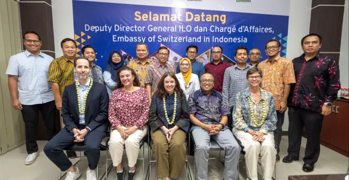 A group photo of ILO Deputy Director-General with Head of KPBS Pengalengan, representatives of Embassy of Switzerland in Indonesia and OJK West Java during the site visit on 21 June.