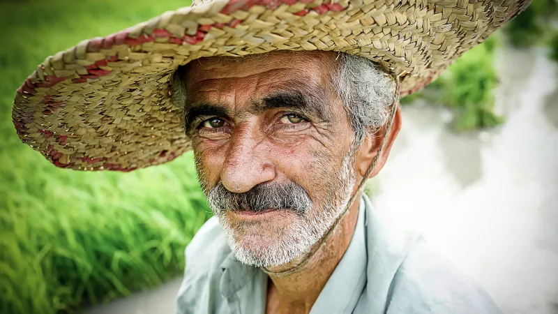 A older farmer from Iran poses for a photo