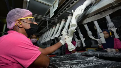 A worker in a Malaysian latex glove factory