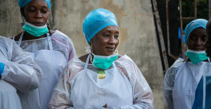 Public health workers learn how to use personal protective equipment at a CDC-GHSA facilitated training in Guinea.